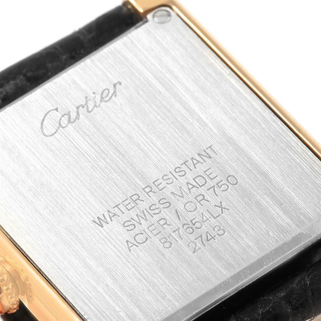 This image shows the back of a Cartier Tank Solo W1018755 Women's Steel and Gold (two tone) Silver Dial W1018755 Women's Steel and Gold (two tone) Silver Dial watch, highlighting its inscriptions and metal details.