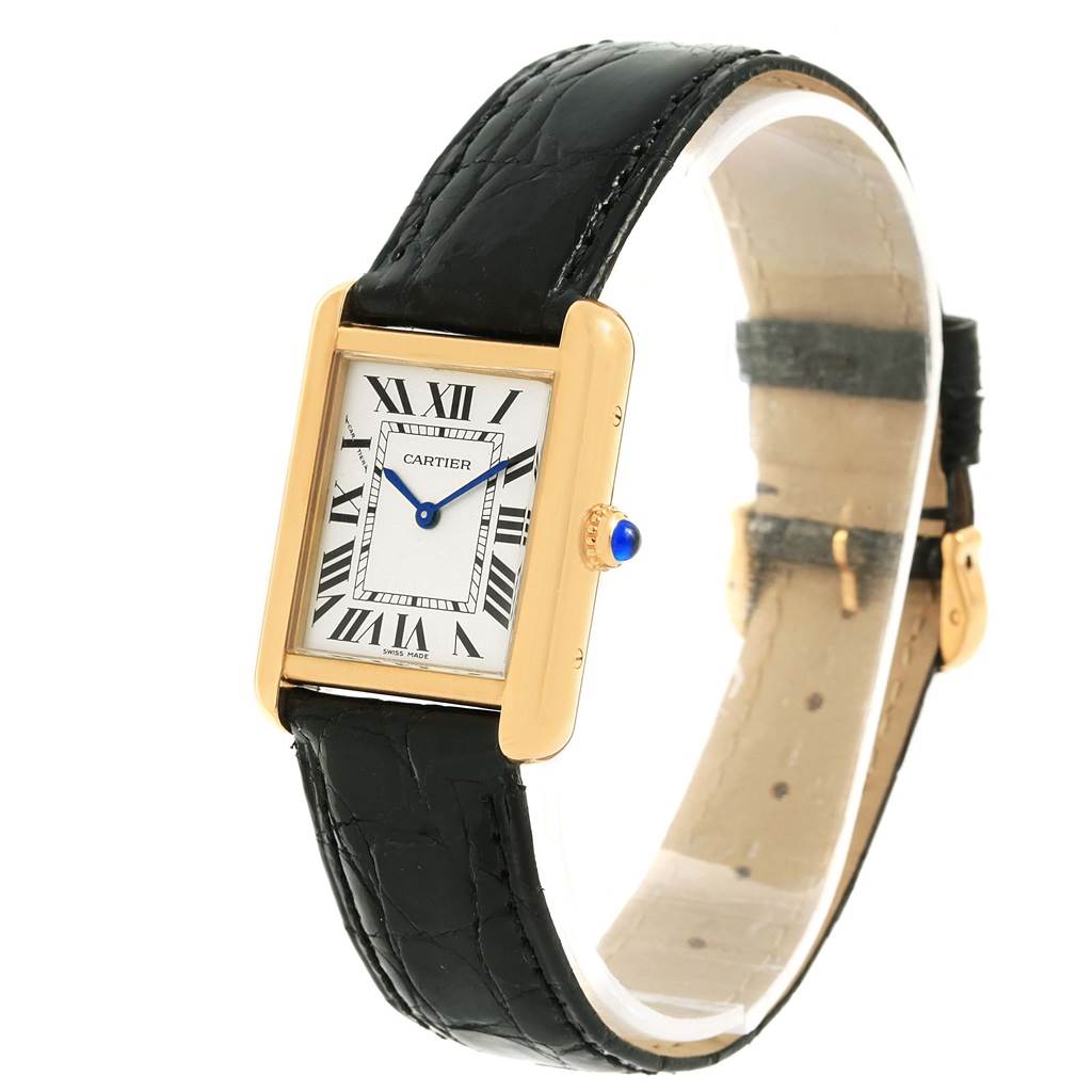 The Cartier Tank Solo W1018755 Women's Steel and Gold (two tone) Silver Dial W1018755 Women's Steel and Gold (two tone) Silver Dial watch is shown at a slight angle, displaying its rectangular face, Roman numerals, blue hands, gold case, and black leather strap.
