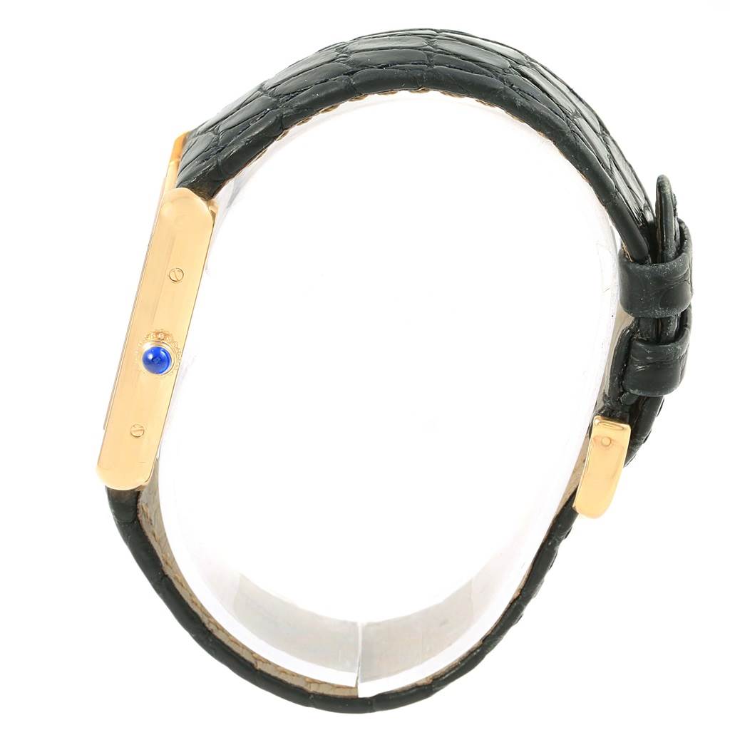 This image shows a side view of the gold case and black leather strap of the Cartier Tank Solo W1018755 Women's Steel and Gold (two tone) Silver Dial W1018755 Women's Steel and Gold (two tone) Silver Dial watch.