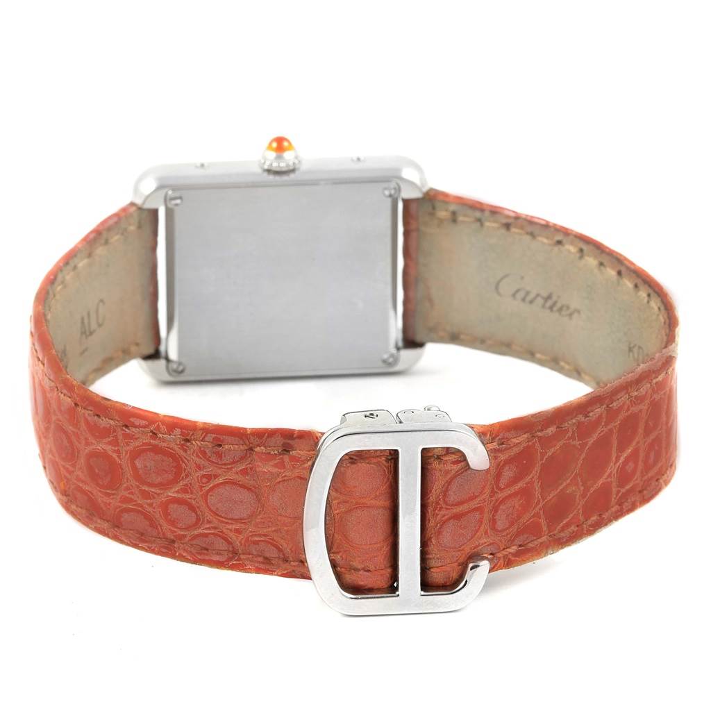 The image shows the back of a Cartier Tank Solo W1019455 Women's Stainless Steel Orange Dial W1019455 Women's Stainless Steel Orange Dial watch with a red leather strap and Cartier's logo on the clasp.