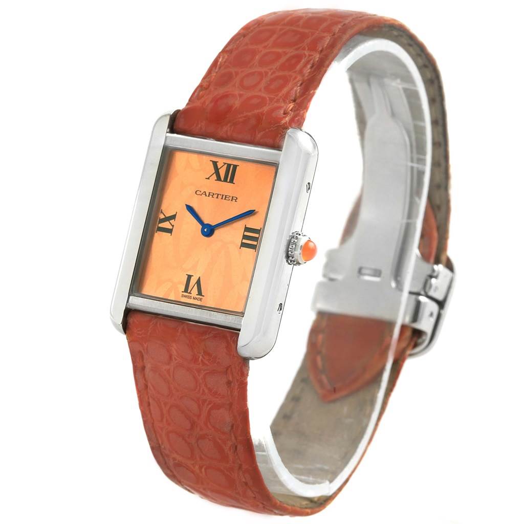 The Cartier Tank Solo W1019455 Women's Stainless Steel Orange Dial W1019455 Women's Stainless Steel Orange Dial watch is shown at an angle, highlighting the rectangular face, Roman numerals, and intricate red strap.