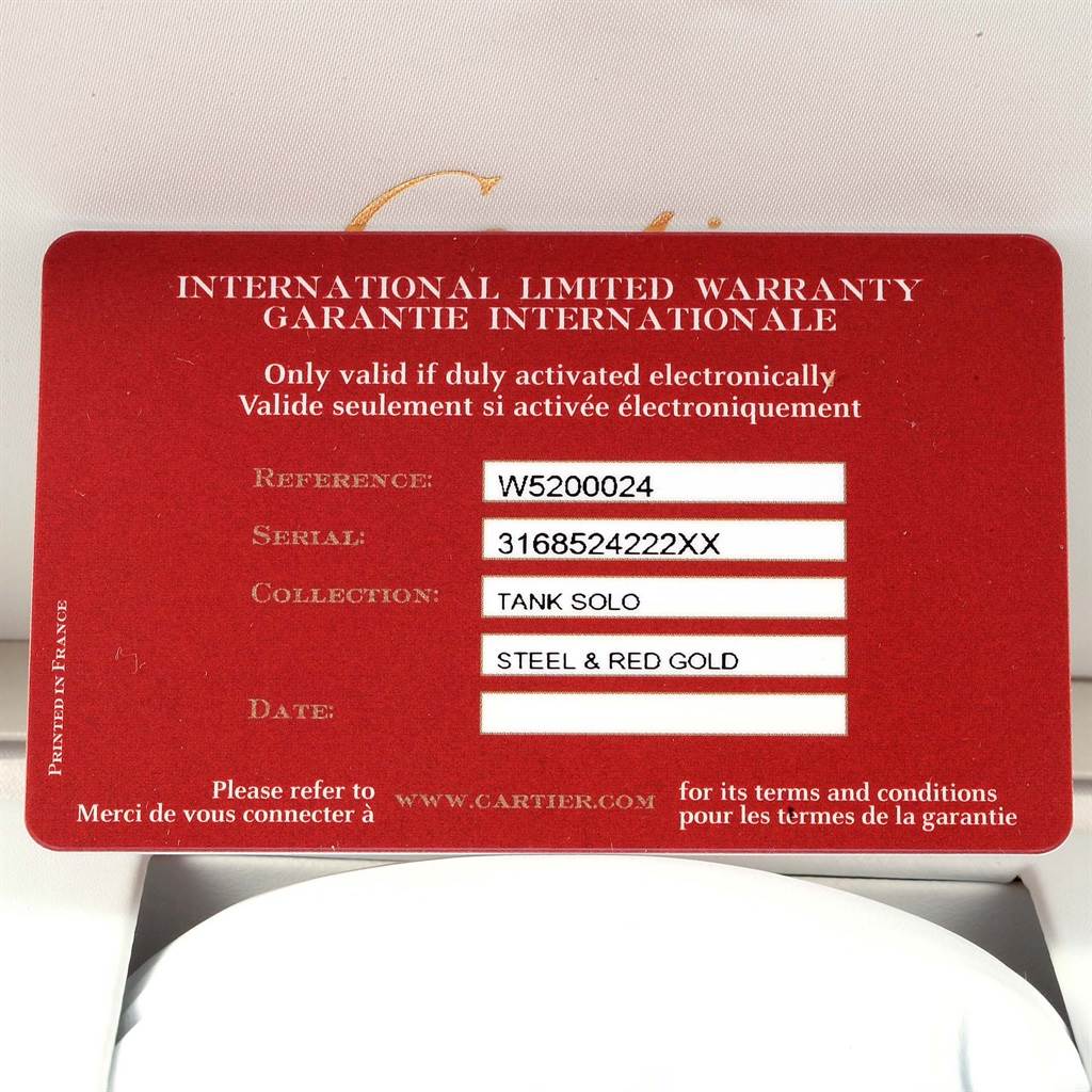 This image shows an international limited warranty card for a Cartier Tank Solo W5200024 Women's Steel and Gold (two tone) Silver Dial W5200024 Women's Steel and Gold (two tone) Silver Dial watch, specifying the model and materials used.