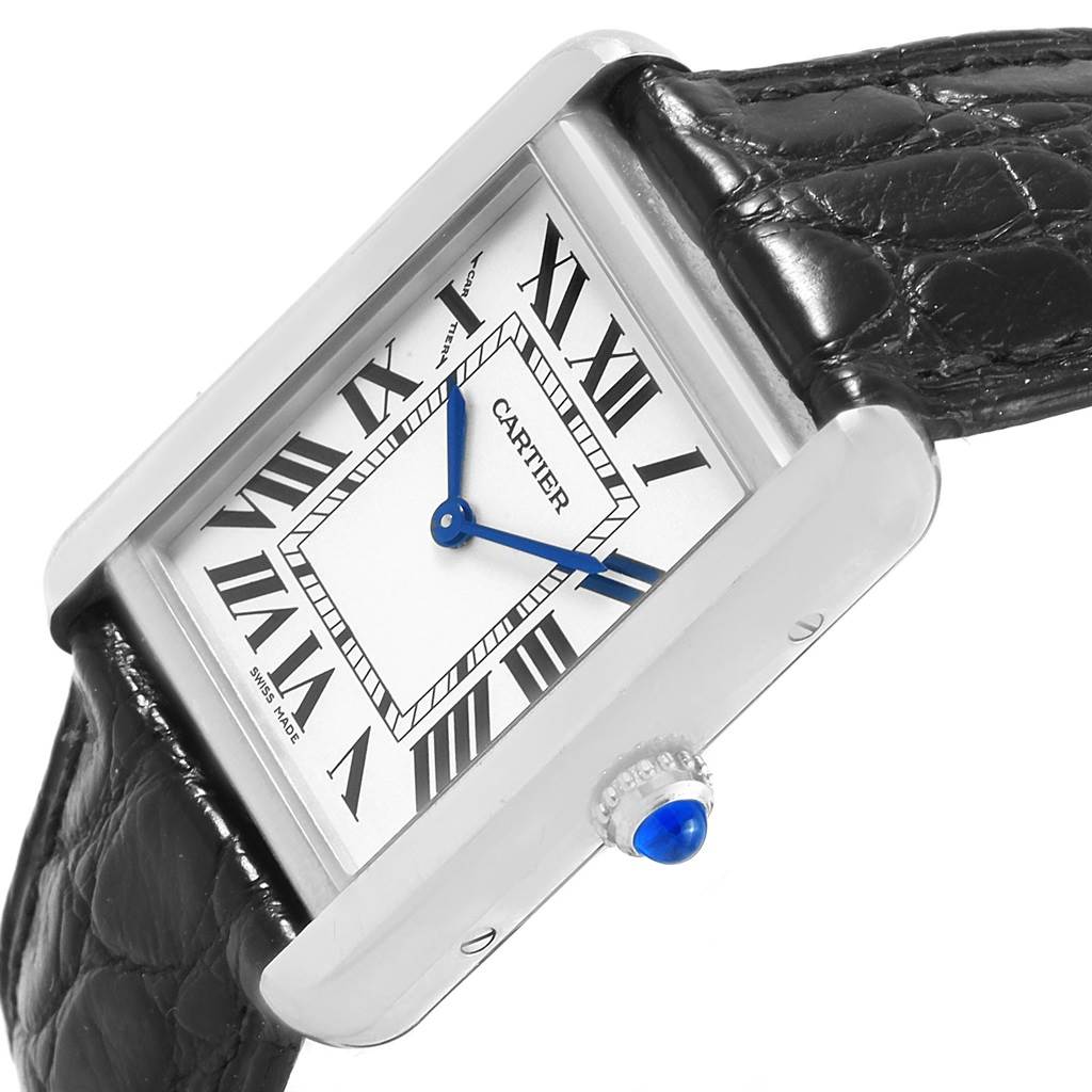 The Cartier Tank Solo W1018255 Women's Stainless Steel Silver Dial W1018255 Women's Stainless Steel Silver Dial watch is depicted at a slight angle, showcasing its rectangular dial, Roman numerals, blue hands, and black leather strap.