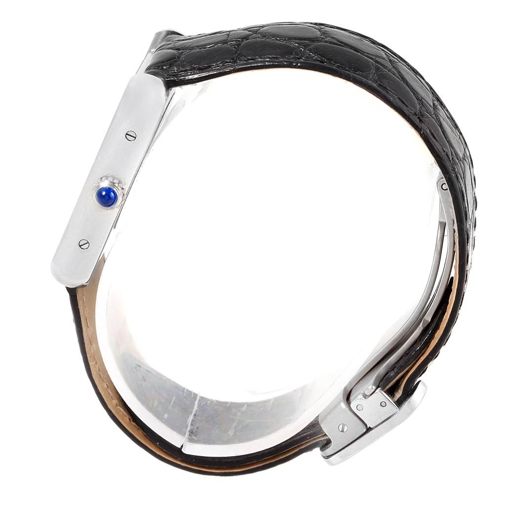 The image shows a side view of the Cartier Tank Solo W1018255 Women's Stainless Steel Silver Dial W1018255 Women's Stainless Steel Silver Dial watch, highlighting the case's profile, crown with a blue cabochon, and black leather strap.