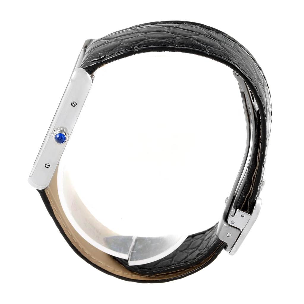 This image shows a side view of the Cartier Tank Solo W1018355 Stainless Steel Silver Dial W1018355 Stainless Steel Silver Dial watch, highlighting its leather strap and crown with a blue cabochon.