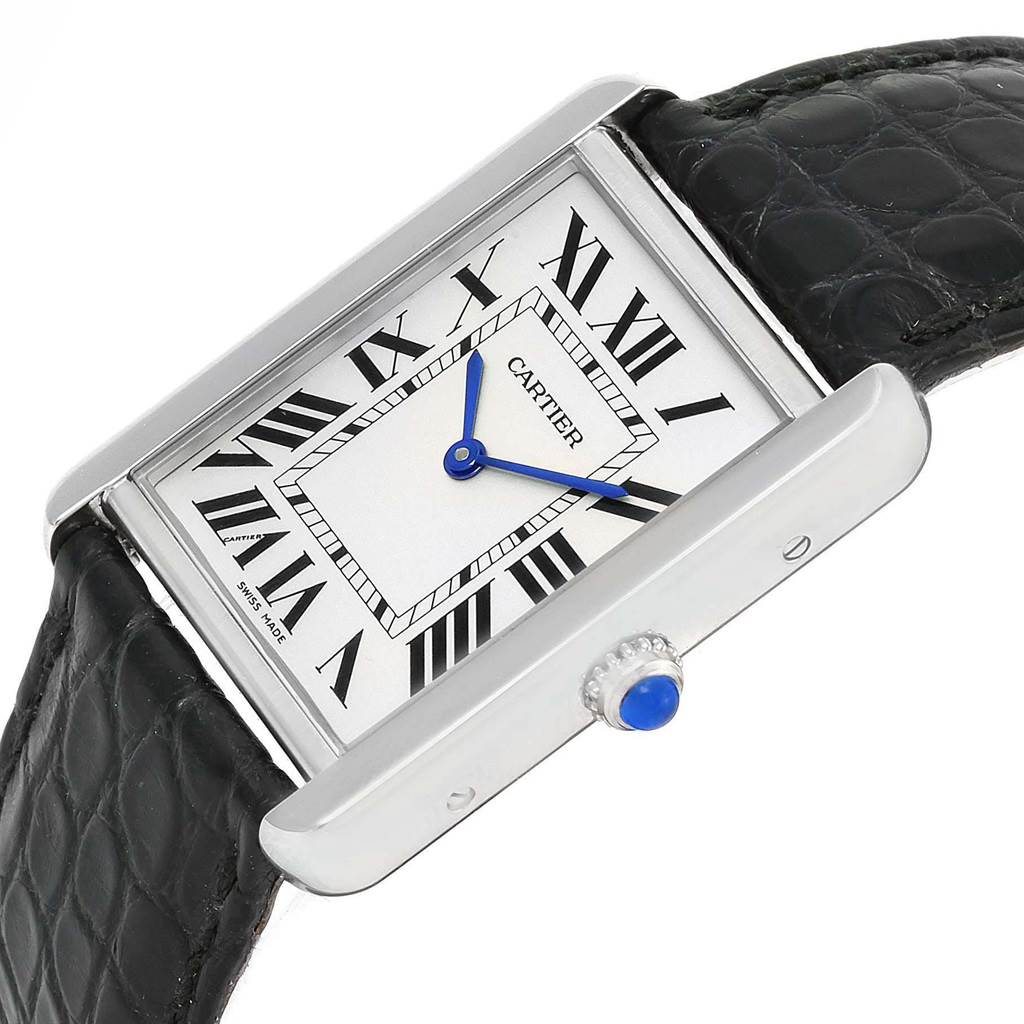 The image shows the face, crown, and part of the black leather strap of a Tank Solo model by Cartier, viewed at an angle.