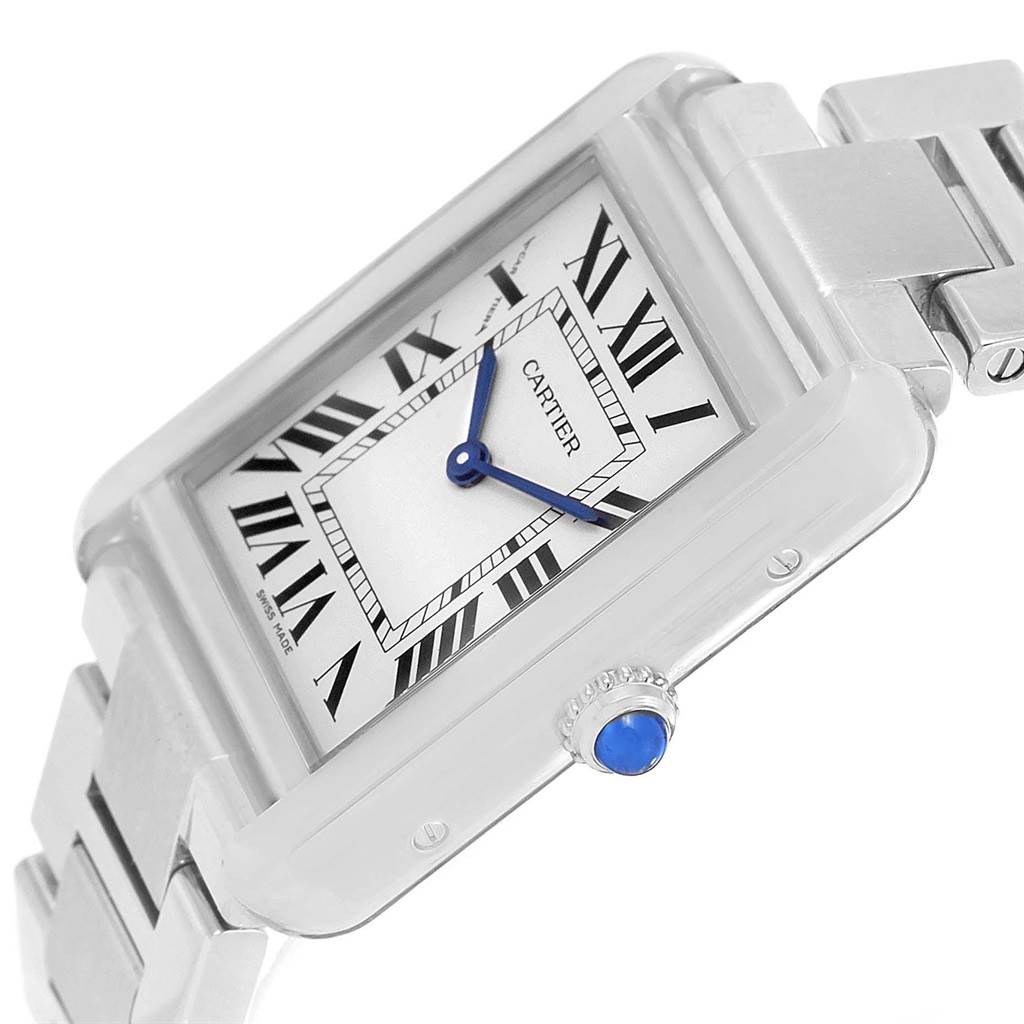 The image shows the face and side of a Cartier Tank Solo W5200013 Women's Stainless Steel Silver Dial W5200013 Women's Stainless Steel Silver Dial watch, highlighting its rectangular dial, Roman numerals, blue hands, and crown with a blue gem.