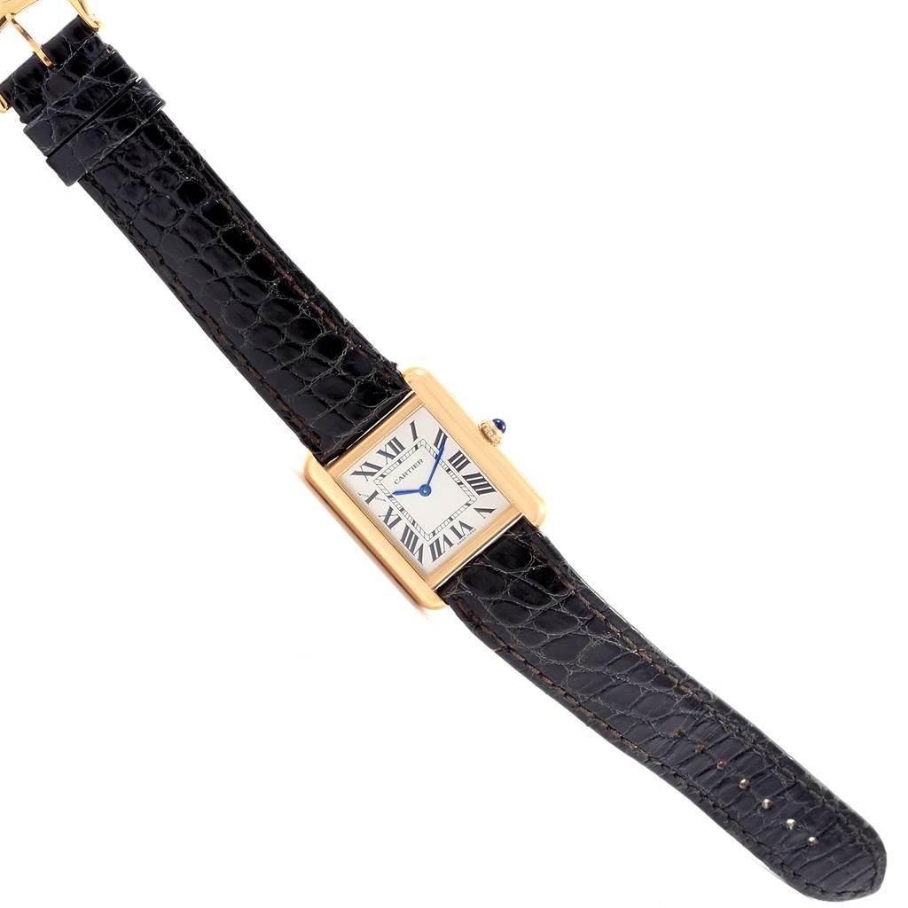 This image shows a full view of the Cartier Tank Solo W1018755 Women's Steel and Gold (two tone) Silver Dial W1018755 Women's Steel and Gold (two tone) Silver Dial watch, featuring its rectangular face, gold casing, and black leather strap.