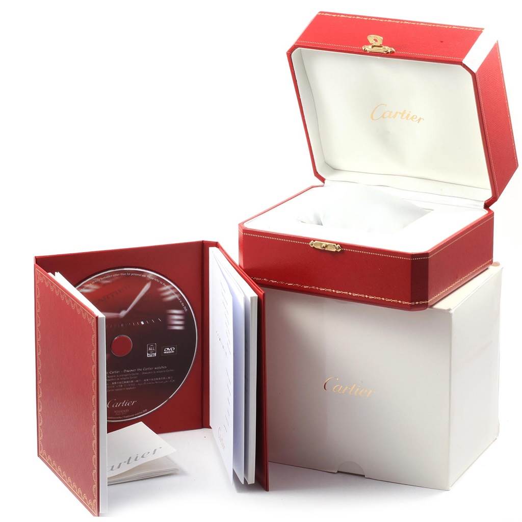 The image shows the packaging, a red box, a booklet with a CD, and a white protective cushion for the Cartier Tank Solo W5200020 Women's Stainless Steel Blue Dial W5200020 Women's Stainless Steel Blue Dial watch.