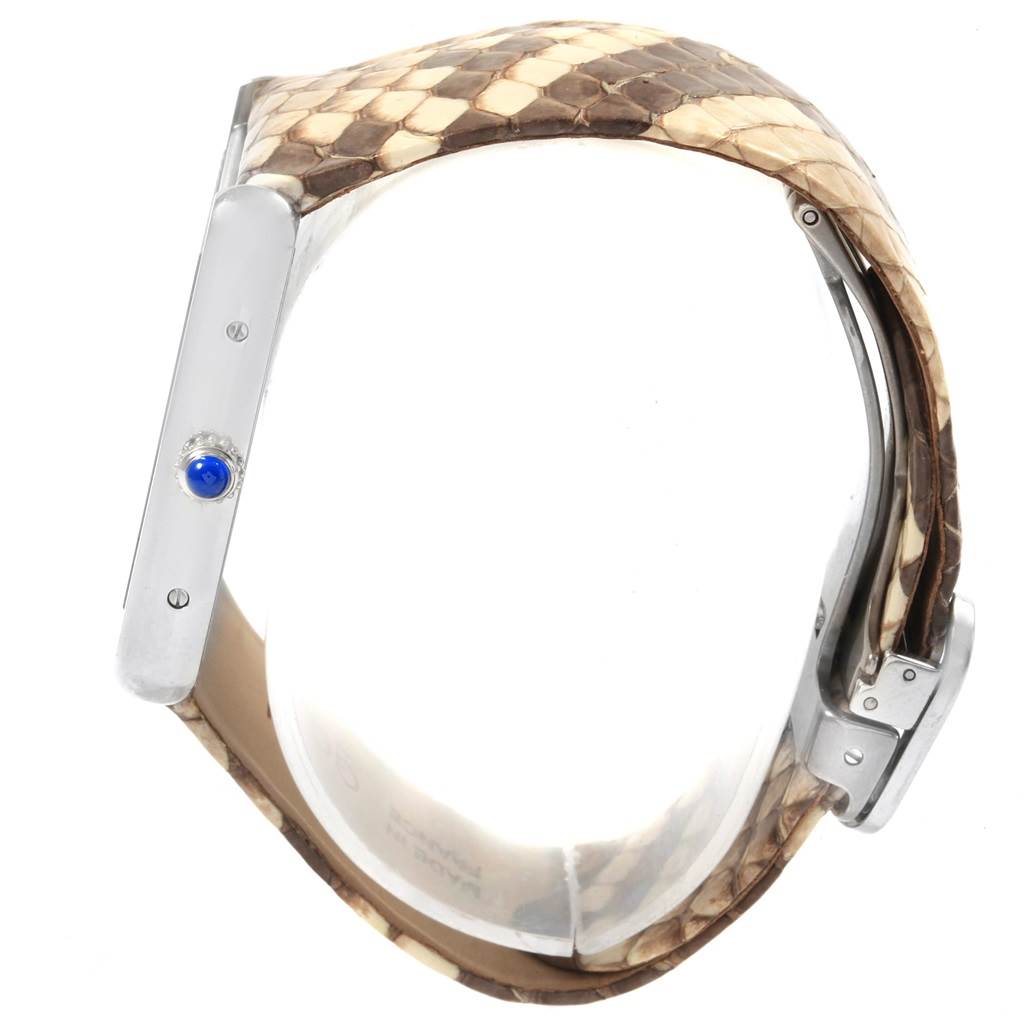 The image shows a side view of the Cartier Tank Solo W5200020 Women's Stainless Steel Blue Dial W5200020 Women's Stainless Steel Blue Dial watch, highlighting the crown with a blue cabochon and part of the snakeskin strap.