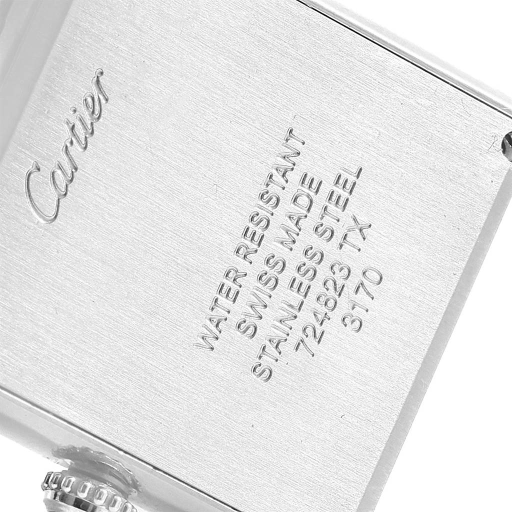 The image shows the back case of a Tank Solo watch by Cartier at a slight angle, highlighting the engravings and crown.