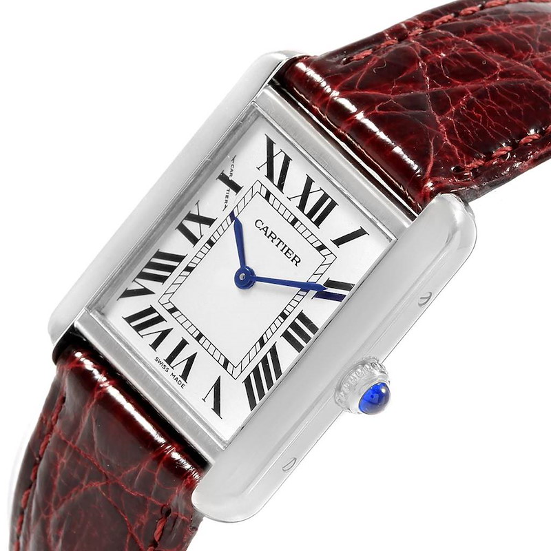 This Cartier Tank Solo watch is shown at a slightly tilted angle, displaying its rectangular face, blue hands, Roman numerals, and leather strap.