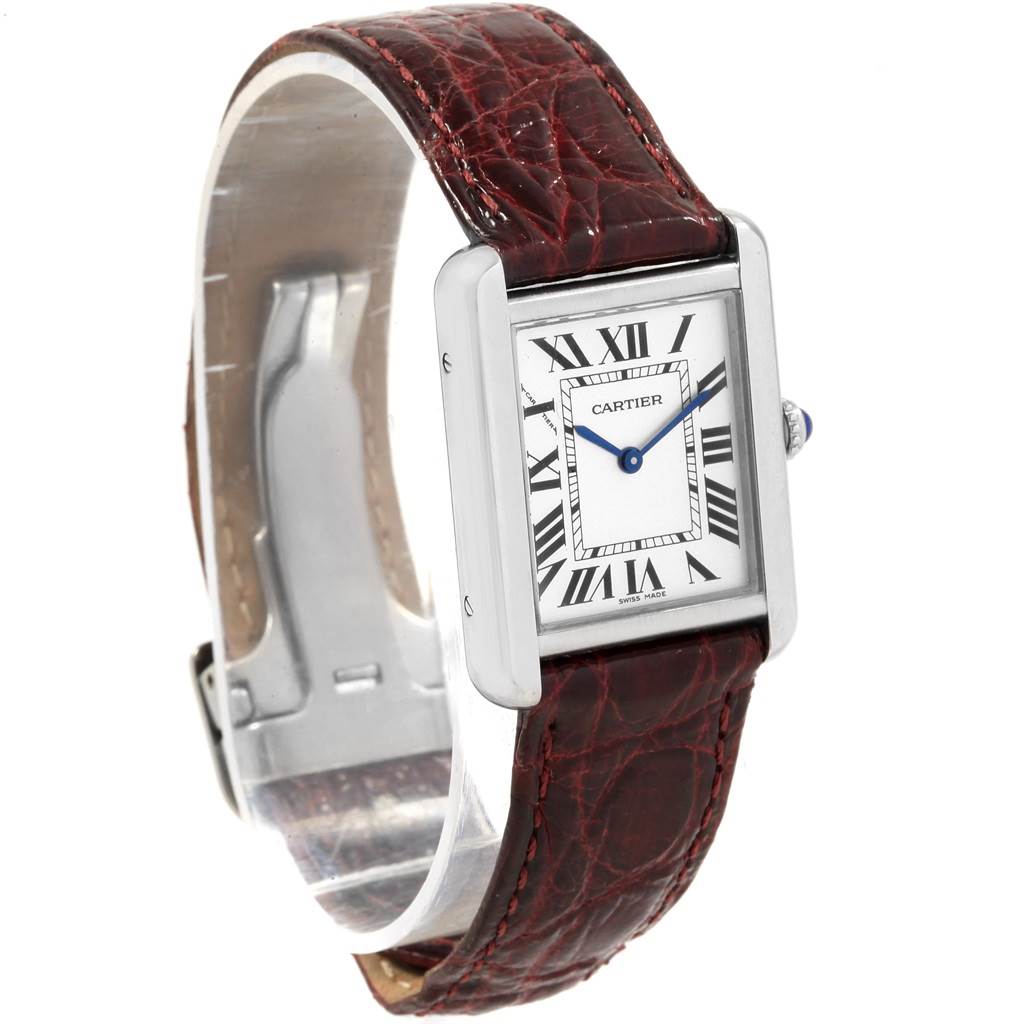 The image shows a Cartier Tank Solo 19908 Women
s Stainless Steel Silver Dial 19908 Women
s Stainless Steel Silver Dial watch at a slight angle, featuring its rectangular face, Roman numerals, blue hands, and red-brown leather strap.