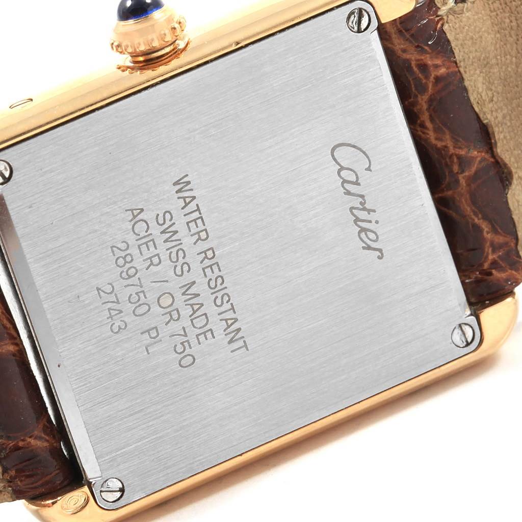 The image shows the back case of a Cartier Tank Solo W1018755 Women's Steel and Gold (two tone) Silver Dial W1018755 Women's Steel and Gold (two tone) Silver Dial watch, highlighting the inscriptions and part of the strap.