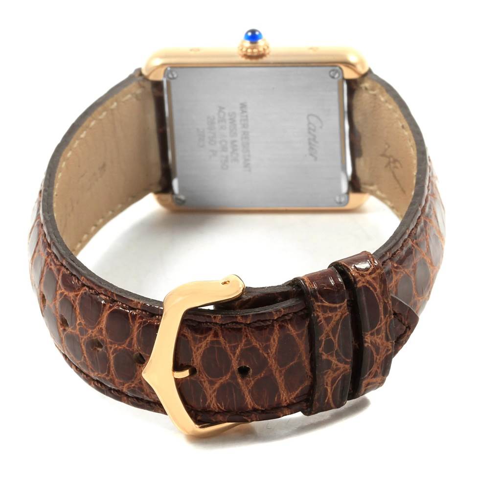 The image shows the rear view of a Cartier Tank Solo W1018755 Women's Steel and Gold (two tone) Silver Dial W1018755 Women's Steel and Gold (two tone) Silver Dial watch, highlighting its case back and brown leather strap with a gold buckle.