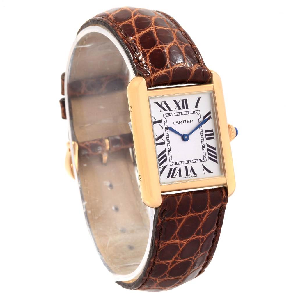The Cartier Tank Solo W1018755 Women's Steel and Gold (two tone) Silver Dial W1018755 Women's Steel and Gold (two tone) Silver Dial watch is shown at an angle, featuring its rectangular dial, gold case, Roman numerals, and brown leather strap.