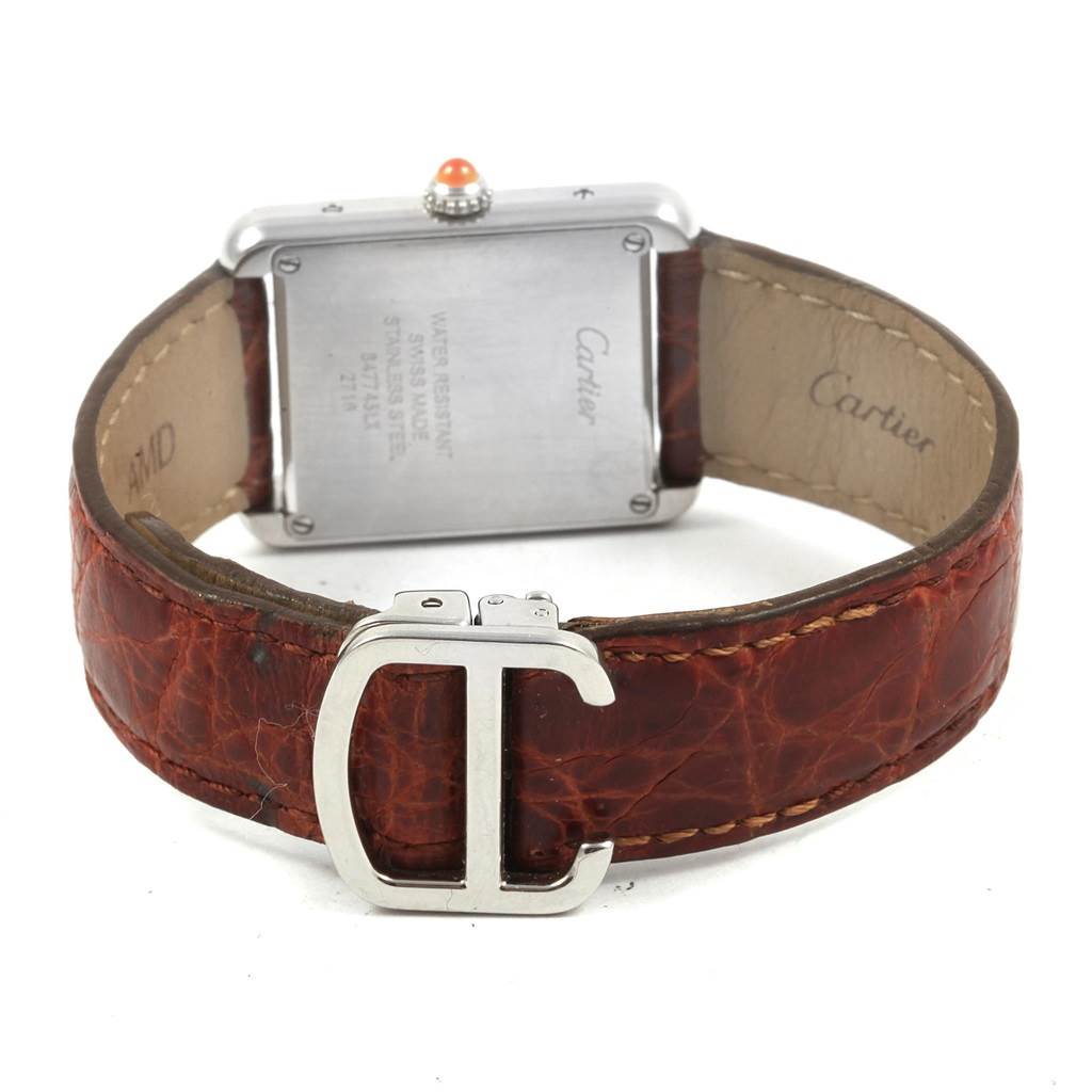 This image shows the back view of a Cartier Tank Solo W1019455 Women's Stainless Steel Orange Dial W1019455 Women's Stainless Steel Orange Dial watch, featuring its leather strap and metal clasp with the Cartier logo.