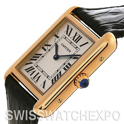 This image shows the Cartier Tank Solo W1018755 Women's Yellow Gold Silver Dial W1018755 Women's Yellow Gold Silver Dial watch at an angle highlighting its face, rectangular case, crown with a blue cabochon, and part of the strap.