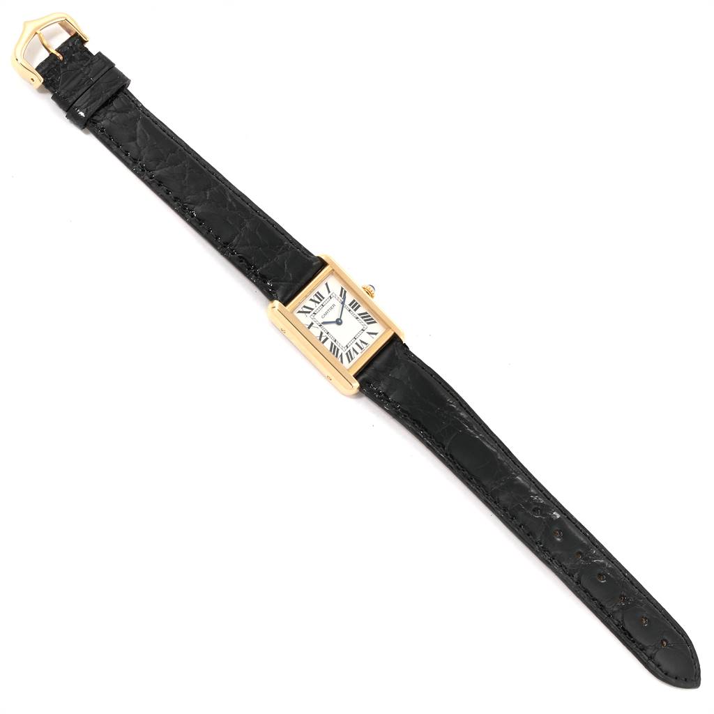 The Cartier Tank Solo W1018755 Women
s Steel and Gold (two tone) Silver Dial W1018755 Women
s Steel and Gold (two tone) Silver Dial watch is shown from a top-down angle, displaying the face, strap, and buckle.