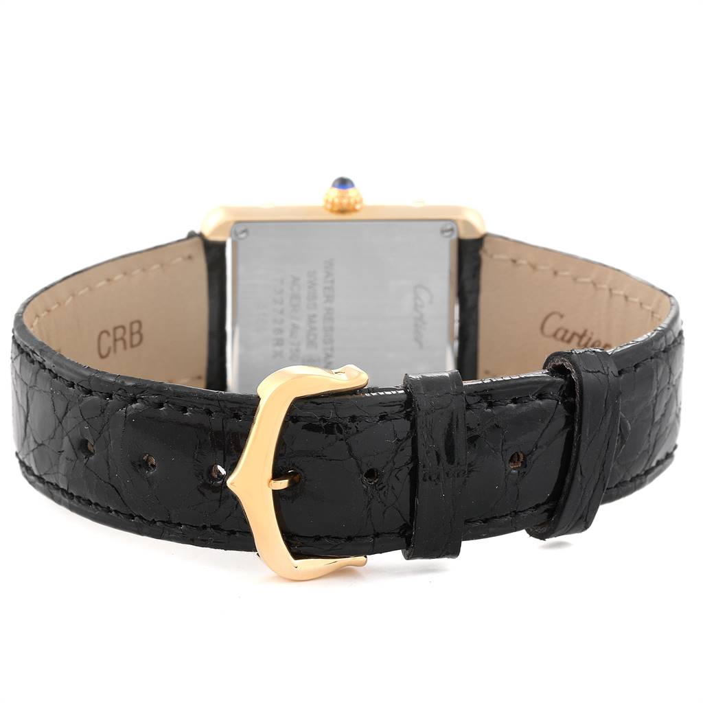 The image shows the back view of the Cartier Tank Solo W1018755 Women
s Steel and Gold (two tone) Silver Dial W1018755 Women
s Steel and Gold (two tone) Silver Dial watch, highlighting the black leather strap and gold-tone buckle.