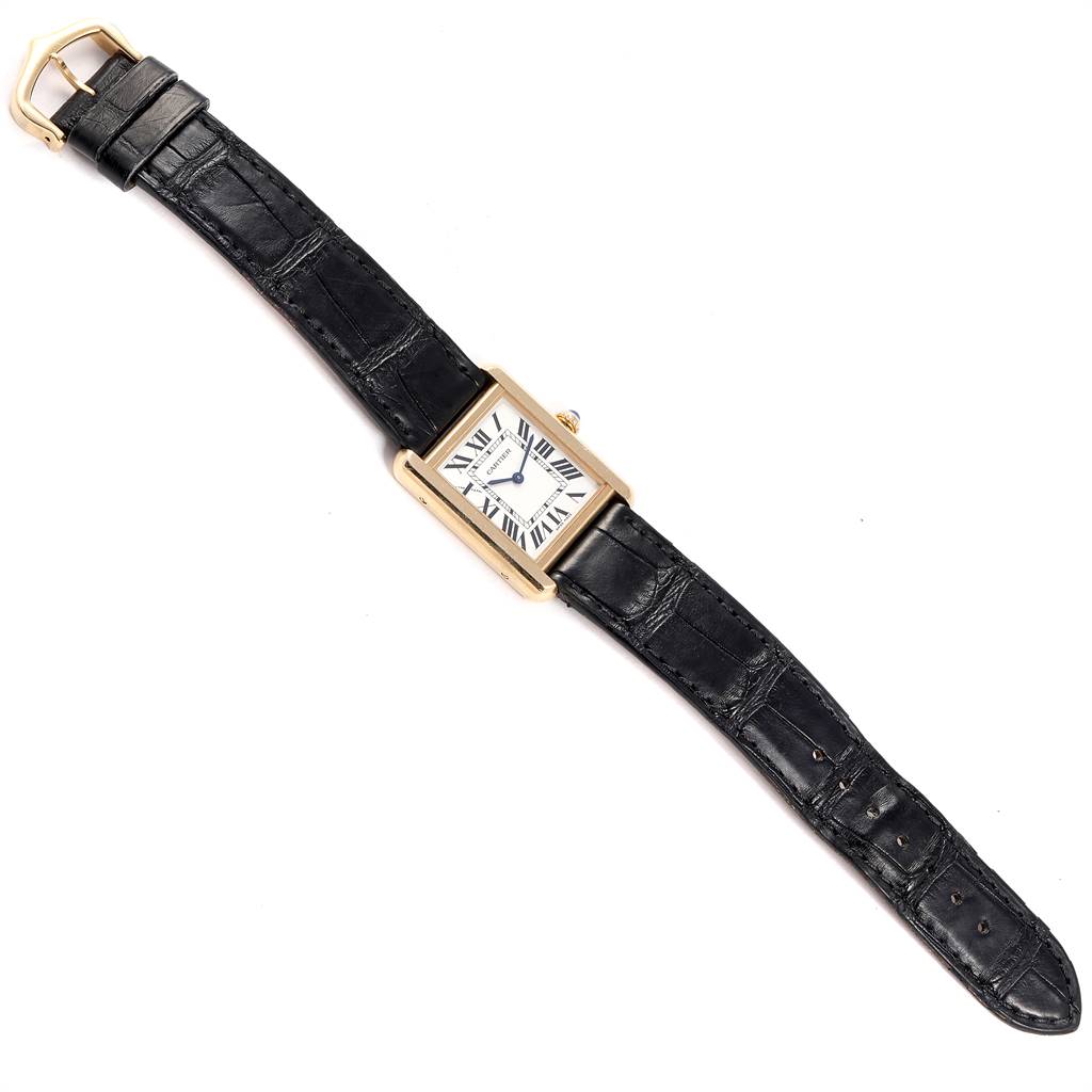 The Cartier Tank Solo W1018755 Women
s Steel and Gold (two tone) Silver Dial W1018755 Women
s Steel and Gold (two tone) Silver Dial watch is shown from an overhead angle, displaying the face, case, and both sections of the black leather strap.
