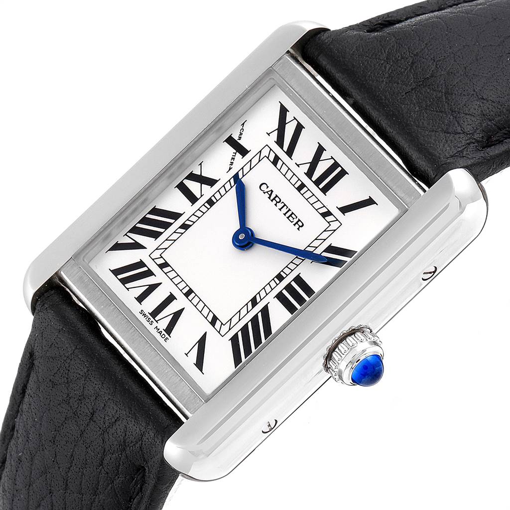 The image shows a Cartier Tank Solo W1018255 Women's Stainless Steel Silver Dial W1018255 Women's Stainless Steel Silver Dial watch at an oblique angle, highlighting its rectangular face, Roman numerals, blue hands, and crown with a blue cabochon.