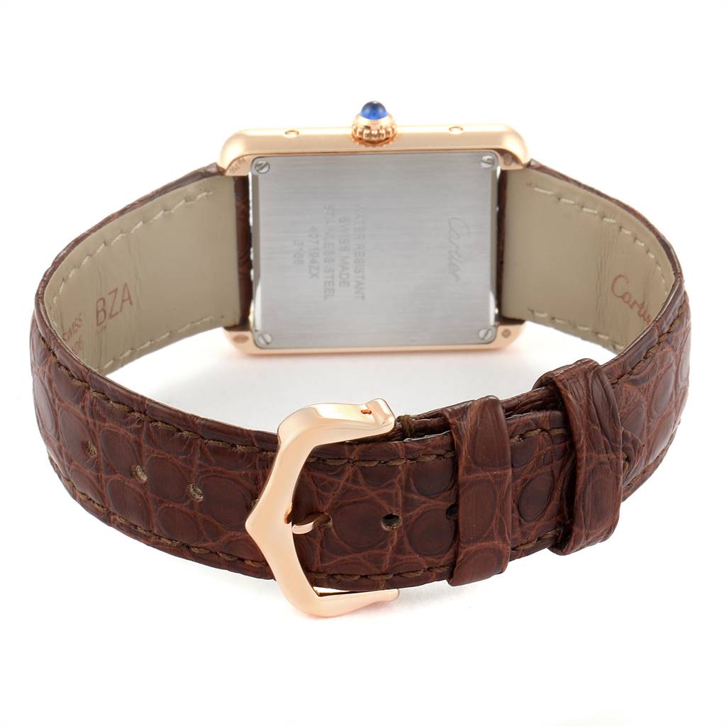 The image shows the back of a Cartier Tank Solo W5200024 Women's Steel and Gold (two tone) Silver Dial W5200024 Women's Steel and Gold (two tone) Silver Dial watch, focusing on the case back, brown leather strap, and buckle.