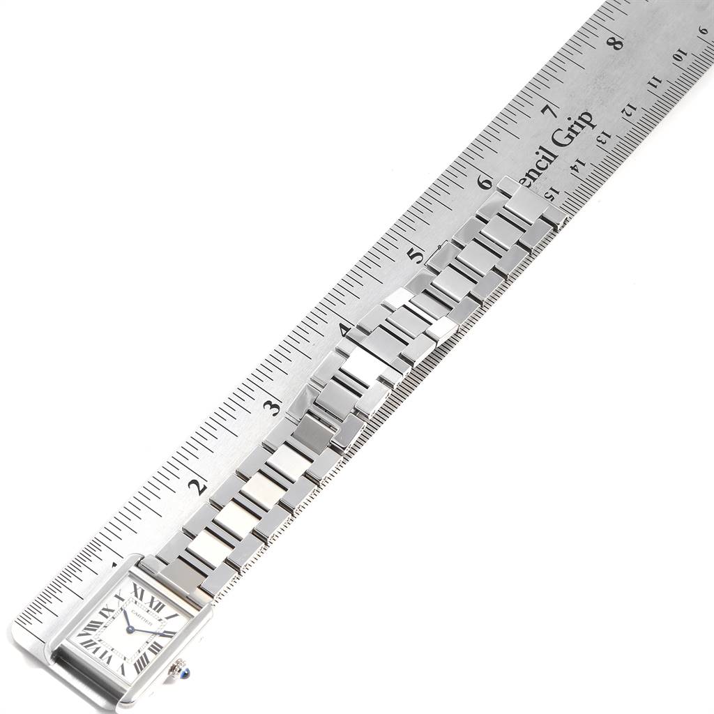 The image shows the face and partial bracelet of a Cartier Tank Solo W5200013 Women
s Stainless Steel Silver Dial W5200013 Women
s Stainless Steel Silver Dial watch alongside a ruler for measurement.