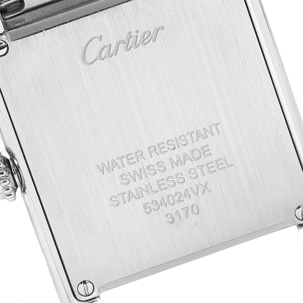 The image shows the back case of a Cartier Tank Solo W5200013 Women
s Stainless Steel Silver Dial W5200013 Women
s Stainless Steel Silver Dial watch, highlighting its engravings and stainless steel construction.
