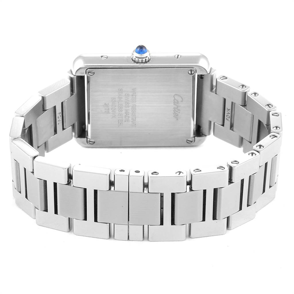 The image shows the back of the Cartier Tank Solo W5200013 Women
s Stainless Steel Silver Dial W5200013 Women
s Stainless Steel Silver Dial watch and its stainless steel bracelet, including the crown with a blue gemstone.