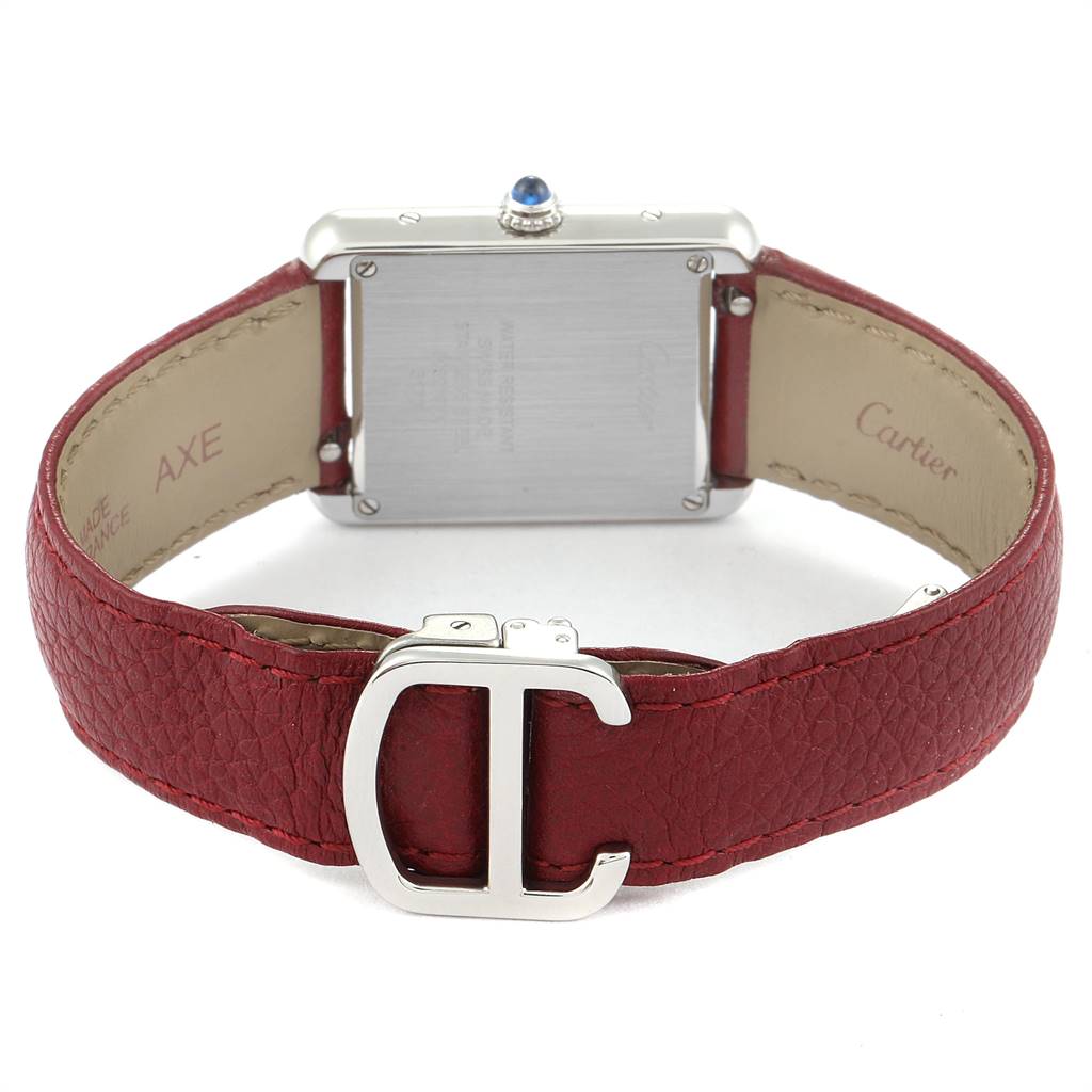 The Tank Solo model by Cartier is shown from the rear, highlighting the case back and red leather band with a clasp.