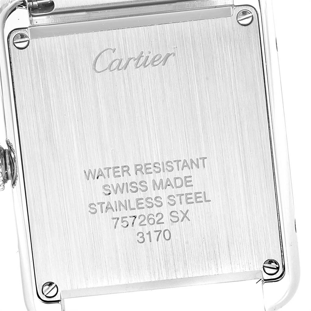 This image shows the back case of a Cartier Tank Solo W5200013 Women
s Stainless Steel Silver Dial W5200013 Women
s Stainless Steel Silver Dial watch, revealing inscriptions and screws.