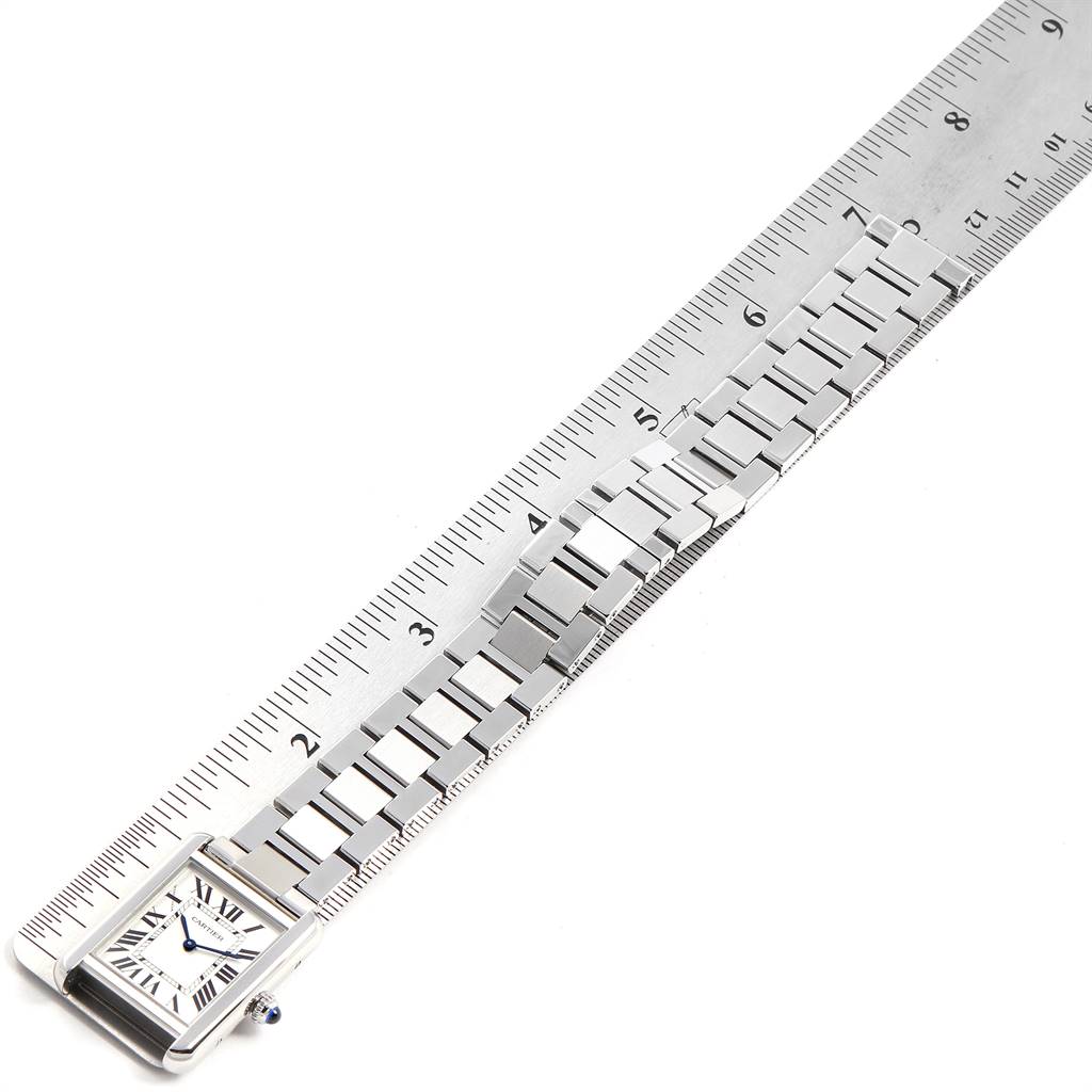 The Cartier Tank Solo W5200013 Women's Stainless Steel Silver Dial W5200013 Women's Stainless Steel Silver Dial watch is shown from the front, with a ruler aligned beside its metal band for measurement.