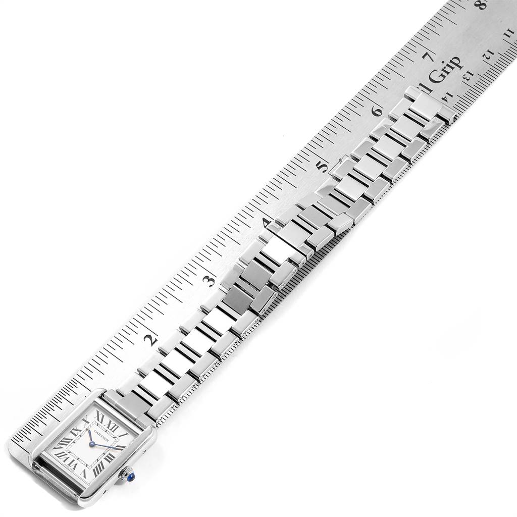 This image shows the Cartier Tank Solo W5200013 Women
s Stainless Steel Silver Dial W5200013 Women
s Stainless Steel Silver Dial watch lying flat next to a ruler, displaying the face and entire metal bracelet.