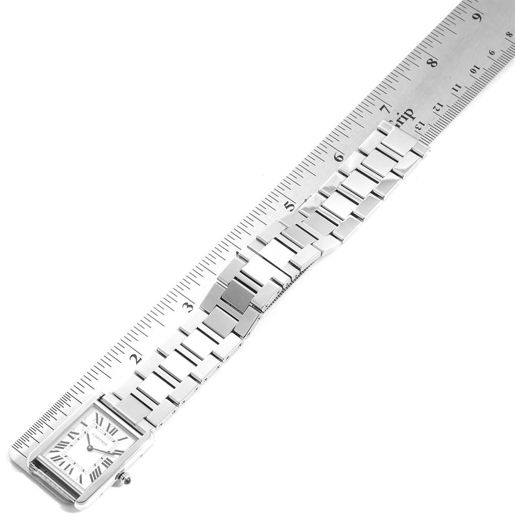 The image shows the face and metal strap of the Cartier Tank Solo W5200014 Men's Stainless Steel Silver Dial W5200014 Men's Stainless Steel Silver Dial model watch laid next to a ruler.