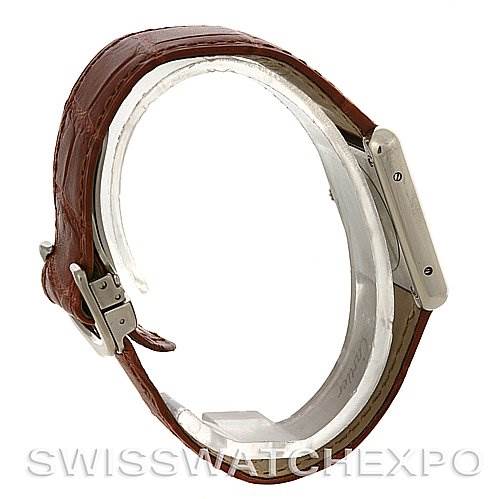 The image shows a side view of a Cartier Tank Solo W5200005 Women's Stainless Steel Silver Dial W5200005 Women's Stainless Steel Silver Dial watch with its brown leather strap and stainless steel case.