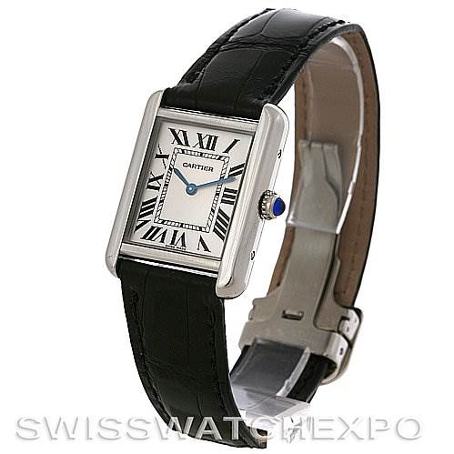 The Cartier Tank Solo W1018255 Women's Stainless Steel Silver Dial W1018255 Women's Stainless Steel Silver Dial watch is shown at an angle highlighting its rectangular face, leather strap, and crown with a blue cabochon.