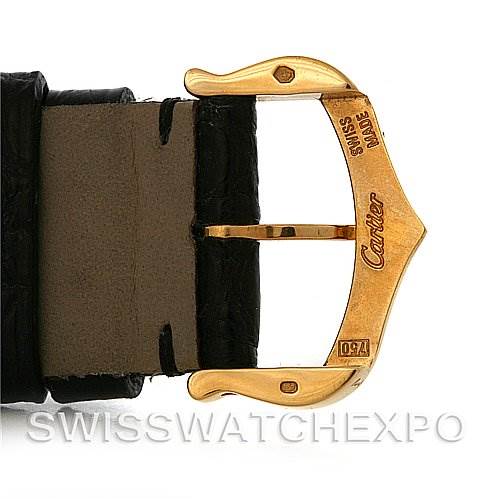 The image shows the gold buckle and part of the leather strap of a Tank Solo watch by Cartier.
