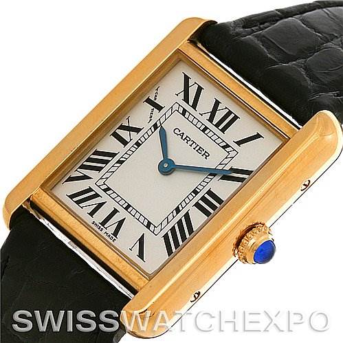 This image shows a Cartier Tank Solo W1018755 Women
s Steel and Gold (two tone) Silver Dial W1018755 Women
s Steel and Gold (two tone) Silver Dial watch from an angled top view, highlighting its gold case, Roman numeral dial, blue hands, and black leather strap.