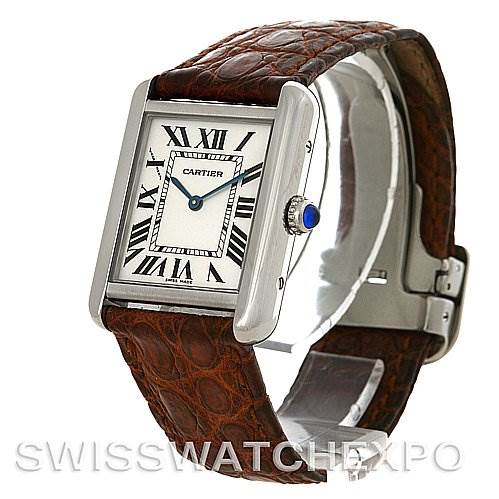 This image shows a Cartier Tank Solo W1018255 Women's Stainless Steel Silver Dial W1018255 Women's Stainless Steel Silver Dial watch from an angled side view, featuring its rectangular face, Roman numerals, and brown leather strap.