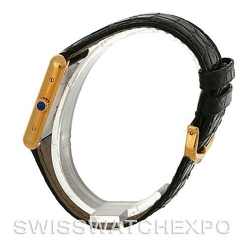 This image shows a Cartier Tank Solo W1018755 Women's Steel and Gold (two tone) Silver Dial W1018755 Women's Steel and Gold (two tone) Silver Dial watch from the side, highlighting the gold case, black leather strap, and crown with a blue cabochon.