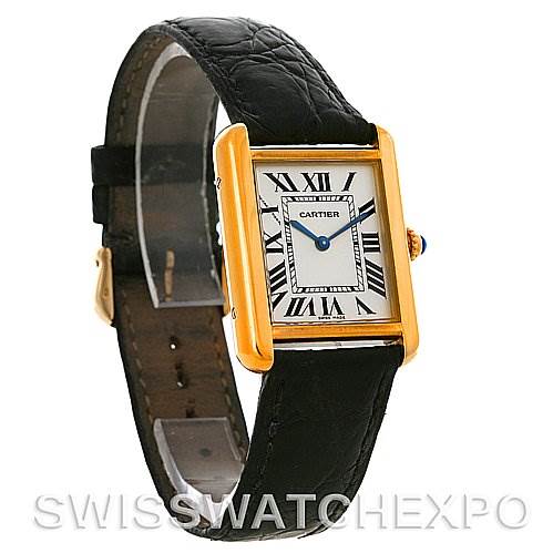 The image shows a Cartier Tank Solo W1018755 Women
s Steel and Gold (two tone) Silver Dial W1018755 Women
s Steel and Gold (two tone) Silver Dial watch at an angled view, highlighting its rectangular gold case, white dial with Roman numerals, and black leather strap.
