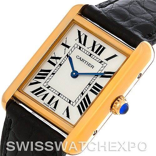 This image shows a Cartier Tank Solo W1018755 Women's Steel and Gold (two tone) Silver Dial W1018755 Women's Steel and Gold (two tone) Silver Dial watch at an angle, displaying its rectangular dial, gold case, black Roman numerals, and black leather strap.