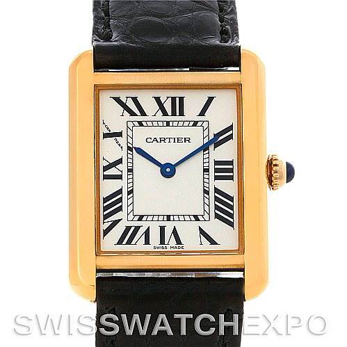 The image shows a frontal view of a Cartier Tank Solo watch, highlighting its rectangular gold case, Roman numeral dial, and black leather strap.