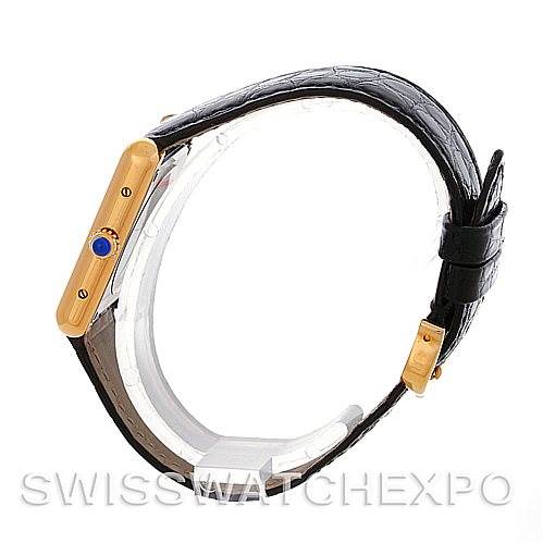 This image of a Cartier Tank Solo W1018755 Women's Steel and Gold (two tone) Silver Dial W1018755 Women's Steel and Gold (two tone) Silver Dial watch shows a side view, highlighting the crown with a blue gem and part of the black leather strap.