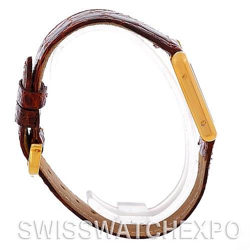 The image shows a side view of the Cartier Tank Solo W1018755 Women's Steel and Gold (two tone) Silver Dial W1018755 Women's Steel and Gold (two tone) Silver Dial watch, highlighting the brown leather strap and gold rectangular case.