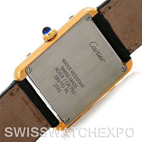 This image shows the back of a Cartier Tank Solo W1018755 Women's Steel and Gold (two tone) Silver Dial W1018755 Women's Steel and Gold (two tone) Silver Dial watch, including the case back and part of the leather strap.