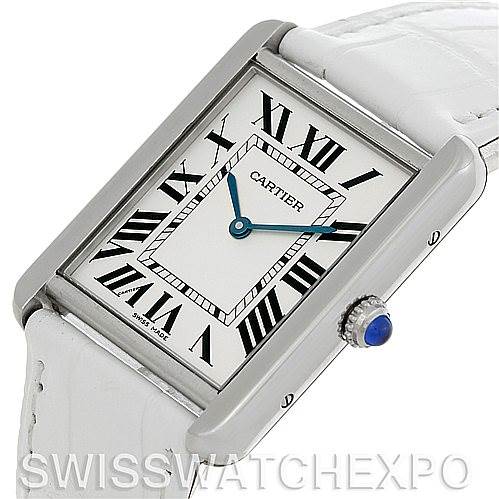The Tank Solo model by Cartier is shown at a slight angle, highlighting its rectangular face, Roman numerals, and white leather strap.