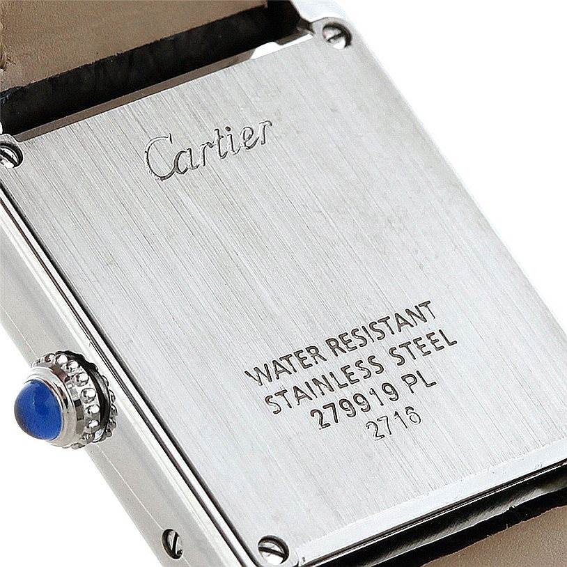 The image shows the back casing of a Cartier Tank Solo W1018255 Women's Stainless Steel Silver Dial W1018255 Women's Stainless Steel Silver Dial watch, highlighting its water resistance, stainless steel composition, and serial numbers.