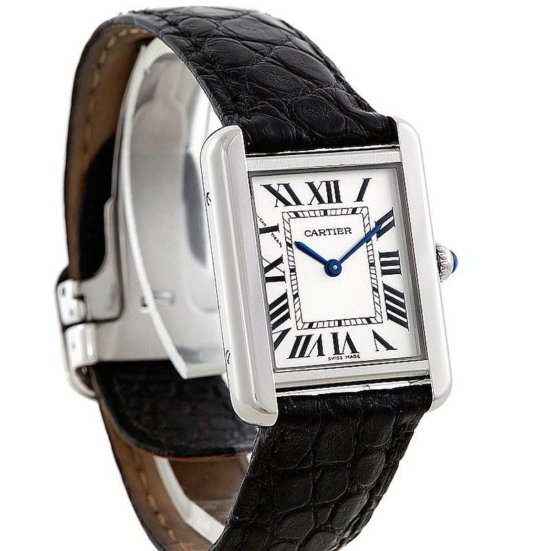 The Cartier Tank Solo watch is shown at an angle featuring the face, Roman numerals, blue hands, and black leather strap.